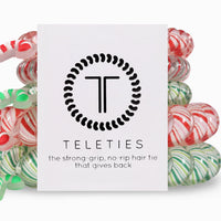 Colorful hair ties with a Teleties branded card on a white background